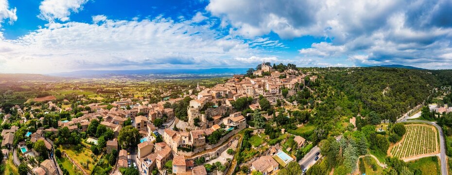 Aerial view of Bonnieux showcasing architecture and serene landscapes, Provence, Luberon, France. Stunning views of Bonnieux medieval village surrounded by lush greenery and hills in Provence.