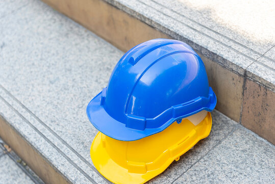 Orange blue white and yellow helmets safety diversity engineering concept