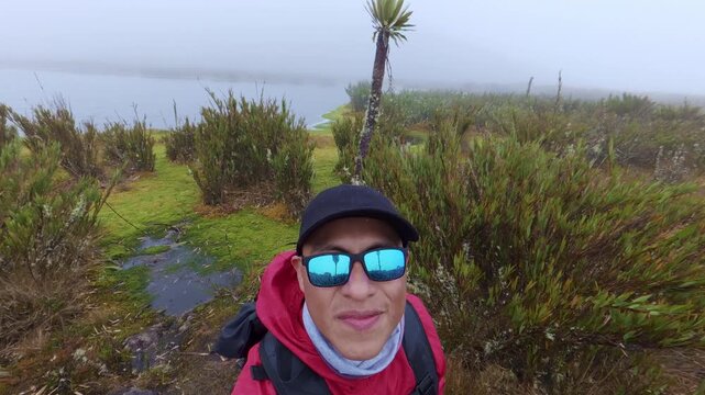 Hiker taking a selfie in a foggy colombian paramo