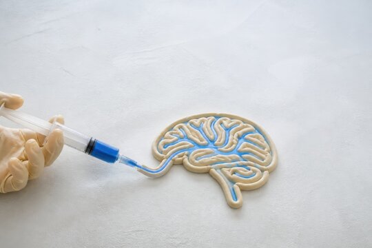 Neurology Concept with Syringe Injecting Brain Model