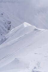 Sculpted snow cornice formations in low winter light, Hokkaido, Japan © foto
