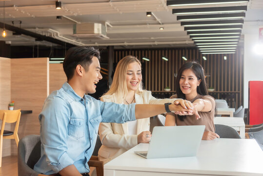 Group of powerful diversity creative people high five on air to greeting power of team. Multiethnic businesspeople working together. Collaboration in Business Team success. StrongTeamwork concept.