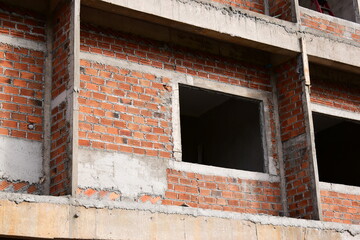 Fototapeta premium exterior view of brick house under construction with concrete structure