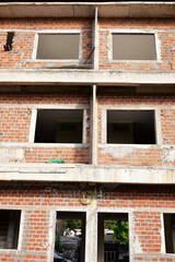 Fototapeta premium exterior view of brick house under construction with concrete structure