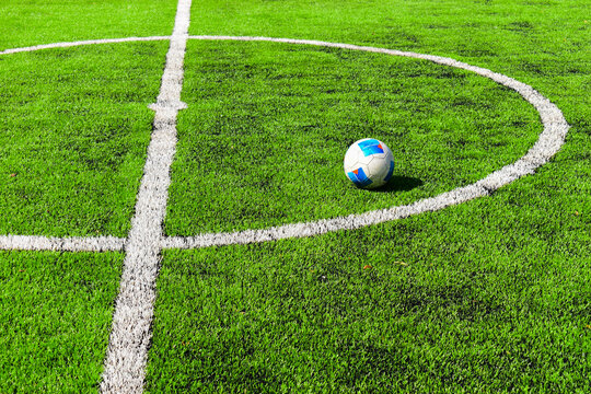 football on green grass pitch with white boundary line marking