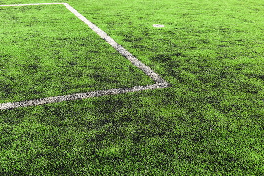 green synthetic grass field texture with white boundary line for sport background