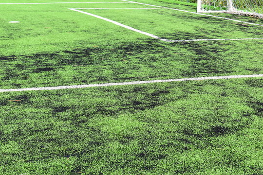 green synthetic grass field texture with white boundary line for sport background