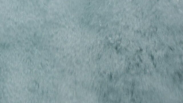 Full frame close up of white water rapids flowing down in slow motion