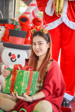 Happy woman in red sweater holding many boxes, Gift box in female hands. Holiday, gift, Holiday gift surprise, Merry Christmas and Happy new year season.
