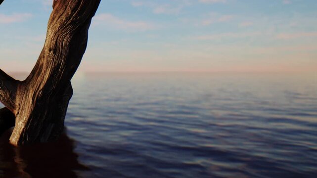 A wooden structure stands at the edge of the water as the sea reflects the colors of the sky. The scene captures a moment by the shoreline during the late afternoon.