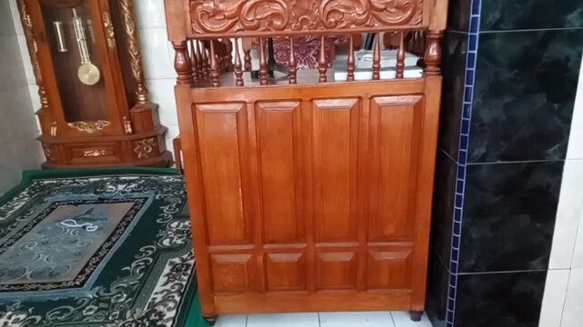 Islamic pulpit mimbar inside abeautiful mosque with bright blue sky view trogh large windouws