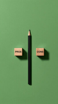 Pros and Cons on Green Background: A simple yet striking composition featuring a pencil centered between two wooden blocks, one labeled PROS and the other CONS.