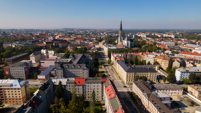 Aerial view of the historic city of Olomouc featuring the prominent St. Wenceslas Cathedral spire surrounded by dense urban architecture and red-tiled rooftops in the Czech Republic.