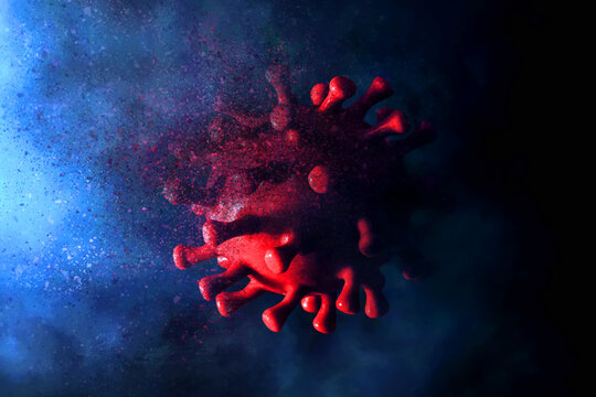 Exploded red virus cell with particle effect on dark background