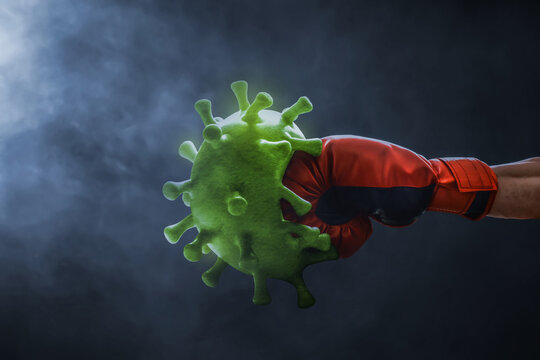 Red boxing glove punching green virus cells