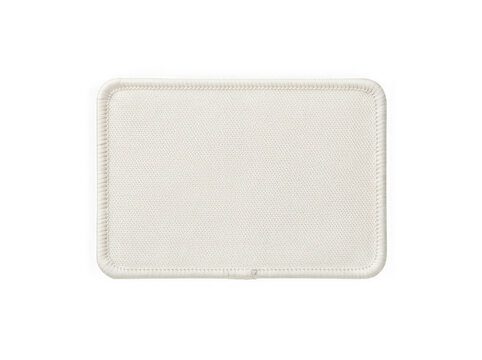 Rectangular beige fabric patch with stitched border edges