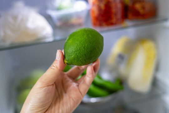 Take a lime out of the refrigerator.