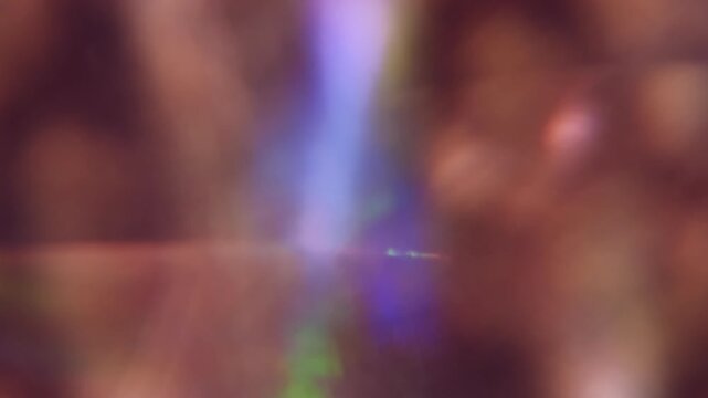 Blur glimmer. Light abstraction. Defocused purple blue green color optical glare radiant gleaming texture leak on luminous art background.