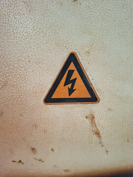 High Voltage Warning Sign on Old Concrete Wall Background