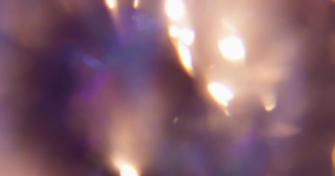 Blur bright glare. Glimmer art. Green blue purple colorful lens flare shiny rainbow gleam kaleidoscope on light abstract bokeh background.