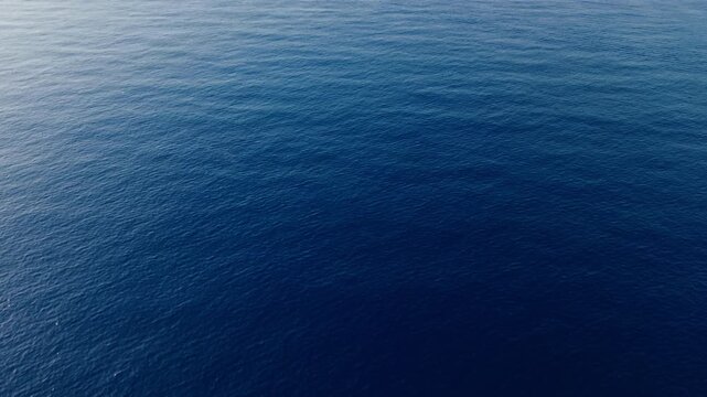 Aerial view of calm blue sea surface on a clear summer day near Genoa, Italy