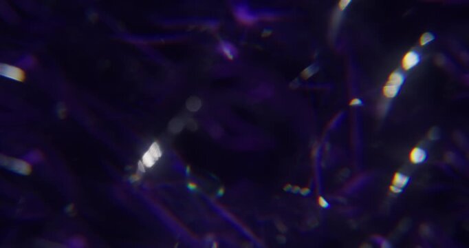 Blur optical glow. Radiant light. Purple red yellow color crystal rainbow flash texture on abstract dark black luminous art background.