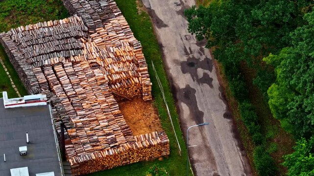 Aerial view of a large pile of logs and a road ready for heating season