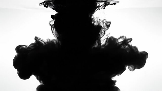 Black ink swirling in water with abstract shapes and fluid motion on white background