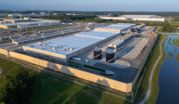 New Albany, United States - 21 August 2026: Aerial view of the Google data center featuring large industrial buildings, cooling towers, and expansive parking lots surrounded by green fields.
