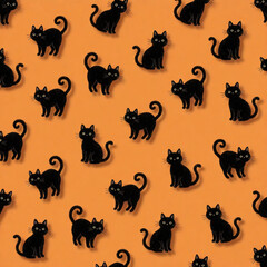 Obraz premium Seamless Halloween pattern with cute black cats on orange background