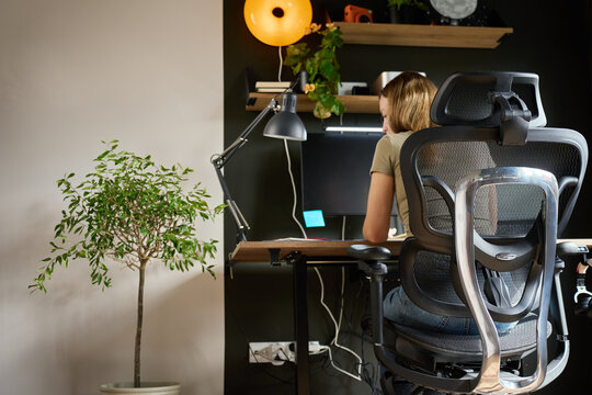 Woman working at desk in home office