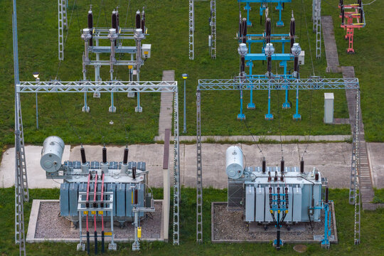 Aerial view of high-voltage substation for hyper-scale data center with electrical transformers and metal structures in Poland.