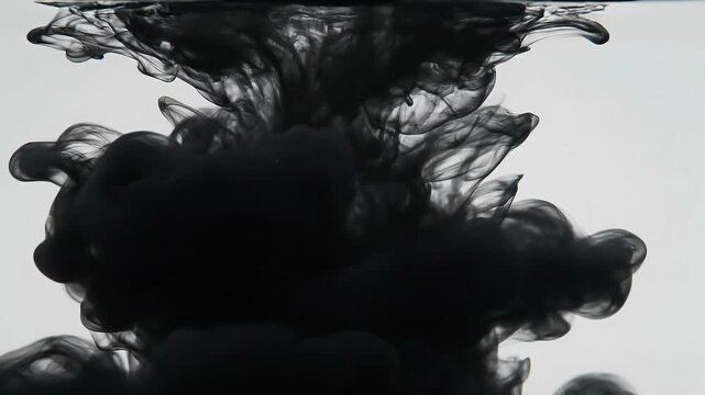 Abstract black ink swirling in clear water with smoke-like patterns and soft gradients