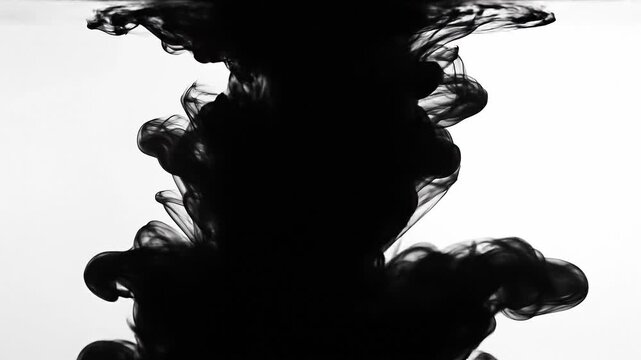 Black ink swirling in clear water with abstract flowing shapes and smoke-like patterns