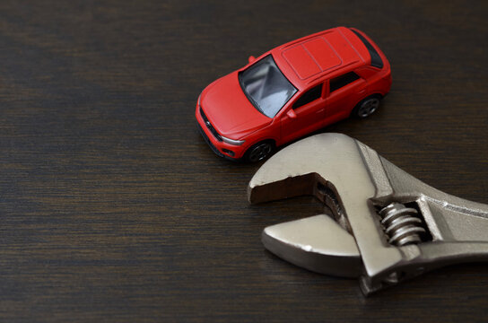 Car Repair and Maintenance Concept with Vehicle Beside Adjustable Wrench