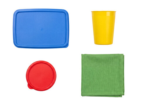 Colorful assortment of reusable food storage lids, a plastic drinking cup, and a green fabric napkin.