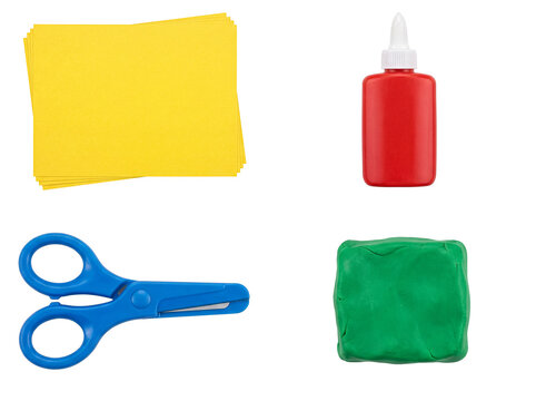Colorful children's craft supplies flat lay, featuring yellow paper, red glue, blue scissors, and green playdough.