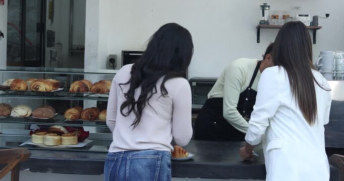 young latin man barista preparing and selling coffee in a coffeeshop in Mexico Latin America