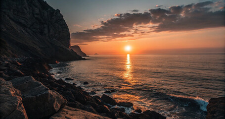 Fototapeta premium Majestic coastal cliff landscape with glowing golden sun reflecting over ocean waves at dusk. Scenic rocky shore seascape at golden hour sunset featuring sun rays pathway on water