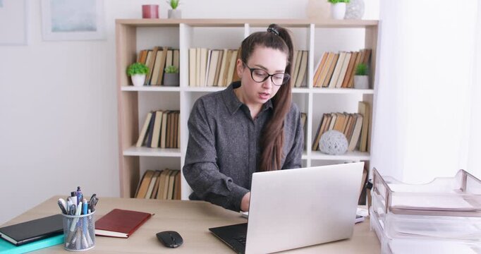Business routine. Professional atmosphere. Busy woman manager at office desk with laptop working with documents at modern workspace.