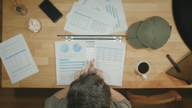 Man Pointing Comparing Financial Reports Data Analysis Desk Business Charts Overhead