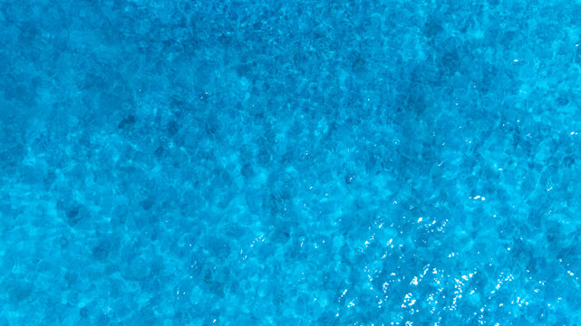 Top view of deep blue sea water surface with small ripples, aerial drone shot of turquoise ocean texture at island , abstract nature background	