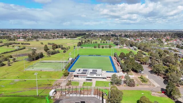 Aerial high-angle view of a&nbsp;community sports facility and&nbsp;recreational reserve with large green space near residential neighborhood in Wyndham Vale, Melbourne, Australia.