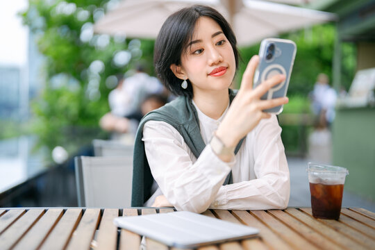 Freelance business adult woman modern lifestyles in downtown relax at outdoor terrace of cafe with coffee drink