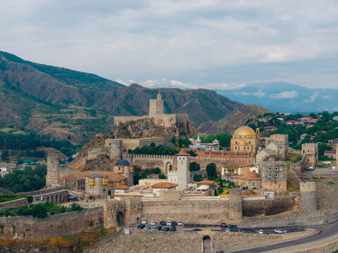 Aerial view of Akhaltsikhe Rabati Castle with its historic stone walls, golden dome, and towers set against a mountainous landscape in Akhaltsikhe, Samtskhe-Javakheti, Georgia.