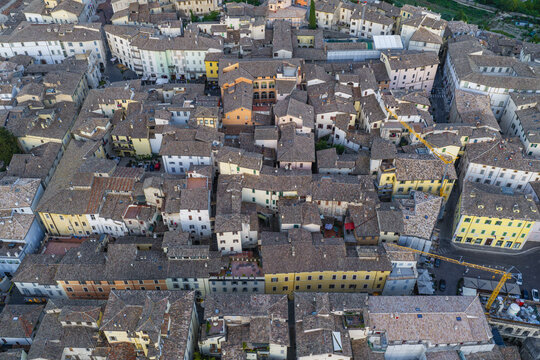 Aerial view of the historic town of Spoleto featuring a dense cluster of terracotta rooftops, narrow streets, and traditional stone architecture in Spoleto, Umbria, Italy.