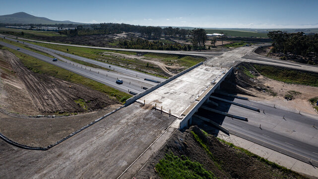 Aerial close-up of a highway intersection under construction in South African highway, showing half-finished road surfaces.