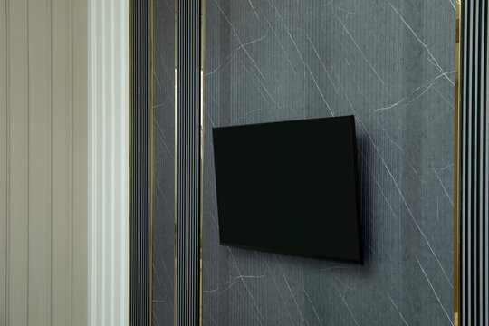 TV is mounted on stylish wall with elegant paneling in contemporary living room
