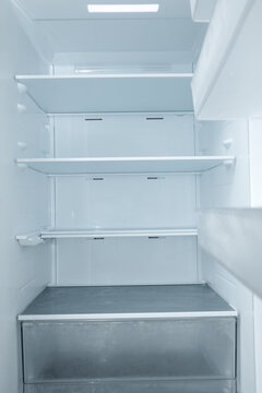 Refrigerator with empty shelves showcases clean lines and minimal design