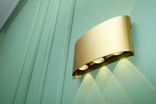 Wall light enhances green wall with a modern design